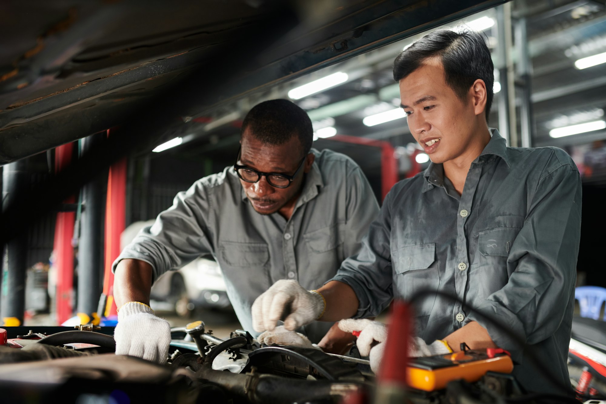 Car Mechanics Checking Engine